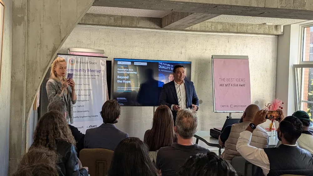 BrowserStack Meetup Amsterdam 2026 — The two talks: Eleonora Belova on Claude + Playwright, and Robert Jadoenandansing on Generative AI in QA (photo 11)