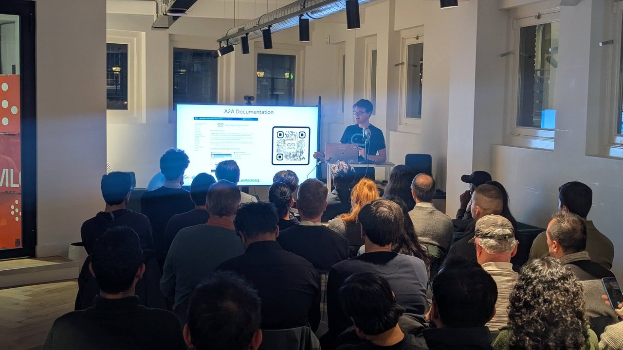 The A2A Documentation slide with a QR code on screen during the Agent2Agent talk at the AICamp meetup at ML6 in Amsterdam
