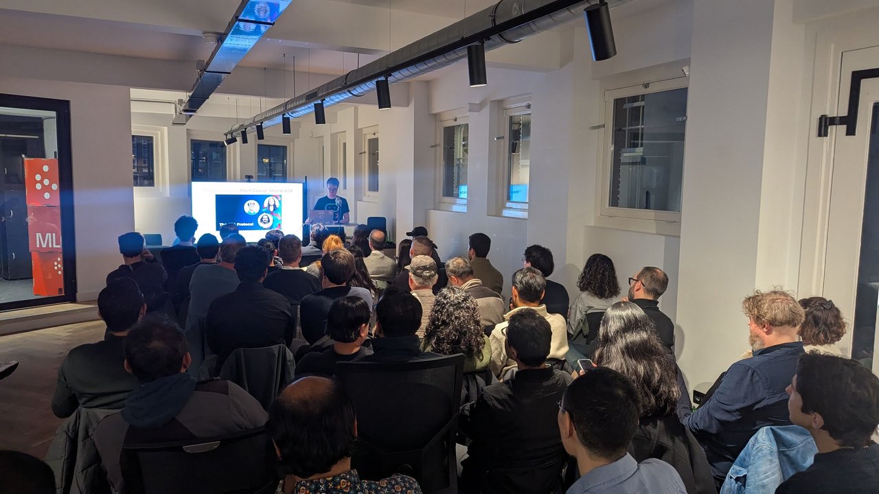 A full room at ML6 in Amsterdam watching the A2A talk, with the DeepLearning.AI Intro to A2A short course slide on screen