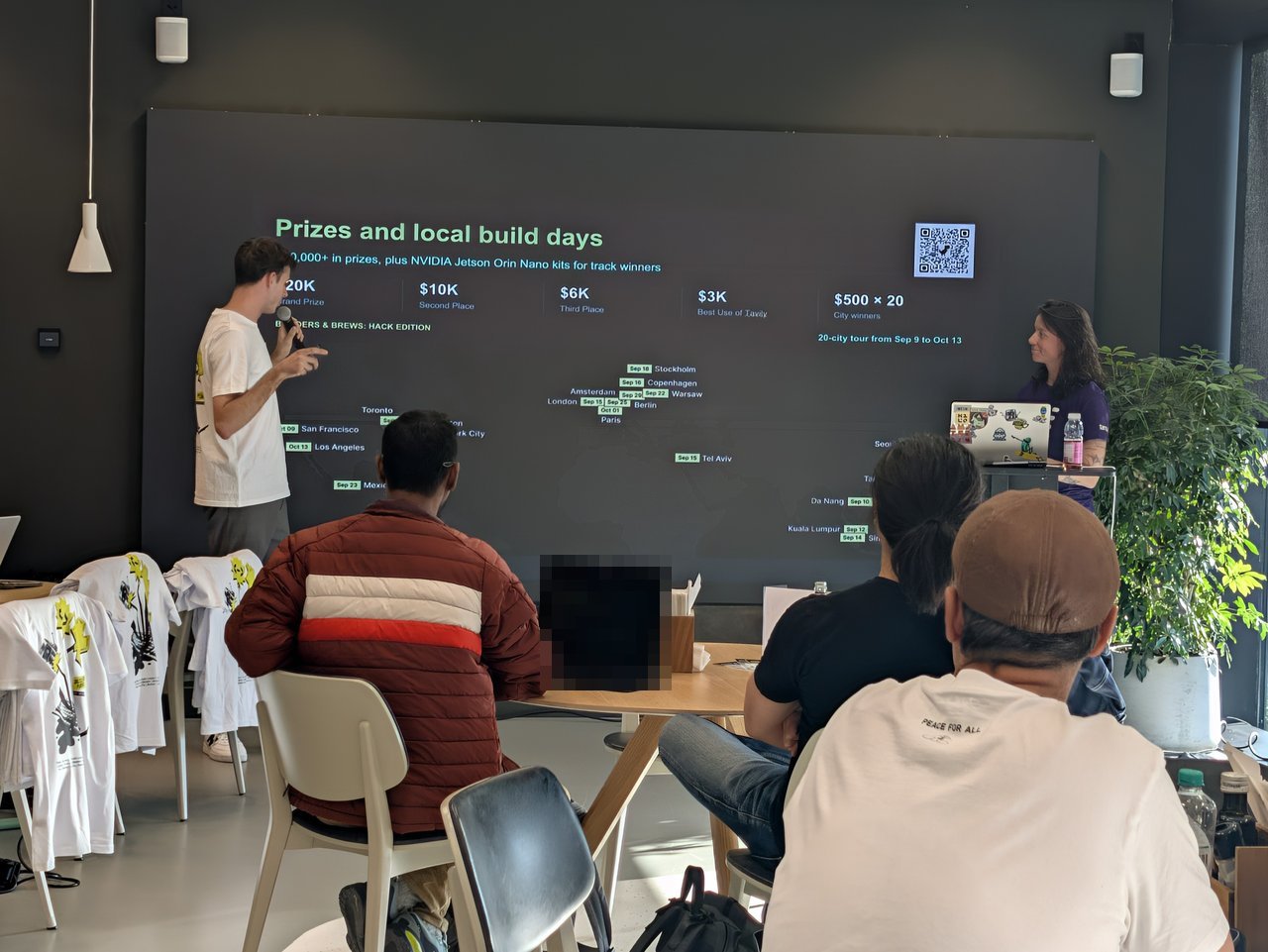Prizes and local build days slide showing $20K grand prize, $10K, $6K, $3K Best Use of Tavily and $500 x 20 city winners above a world map of the 20-city tour