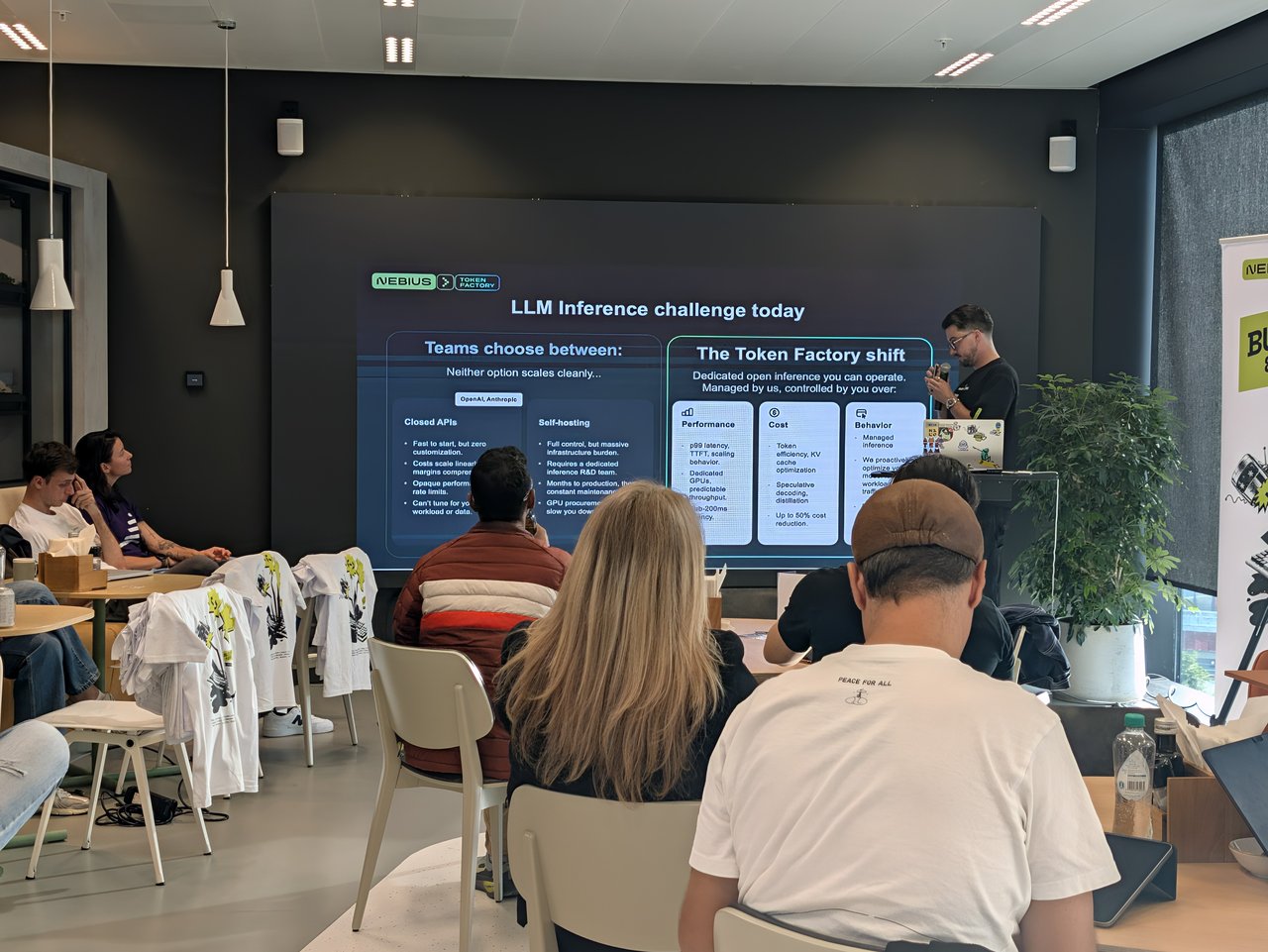 Nebius speaker presenting the LLM Inference challenge today slide comparing closed APIs and self-hosting with The Token Factory shift
