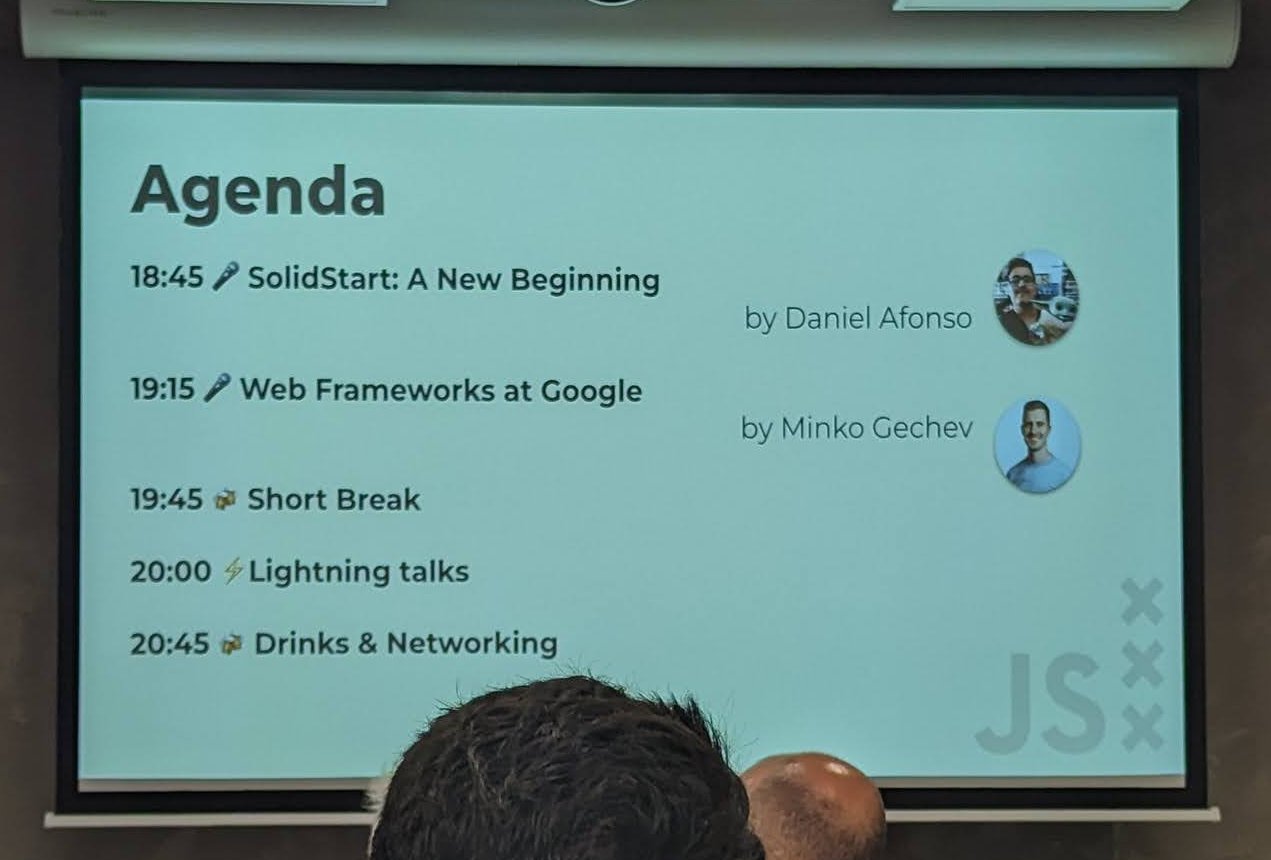 The AdvancedJS Amsterdam agenda slide listing SolidStart: A New Beginning, Web Frameworks at Google, a short break, lightning talks and drinks