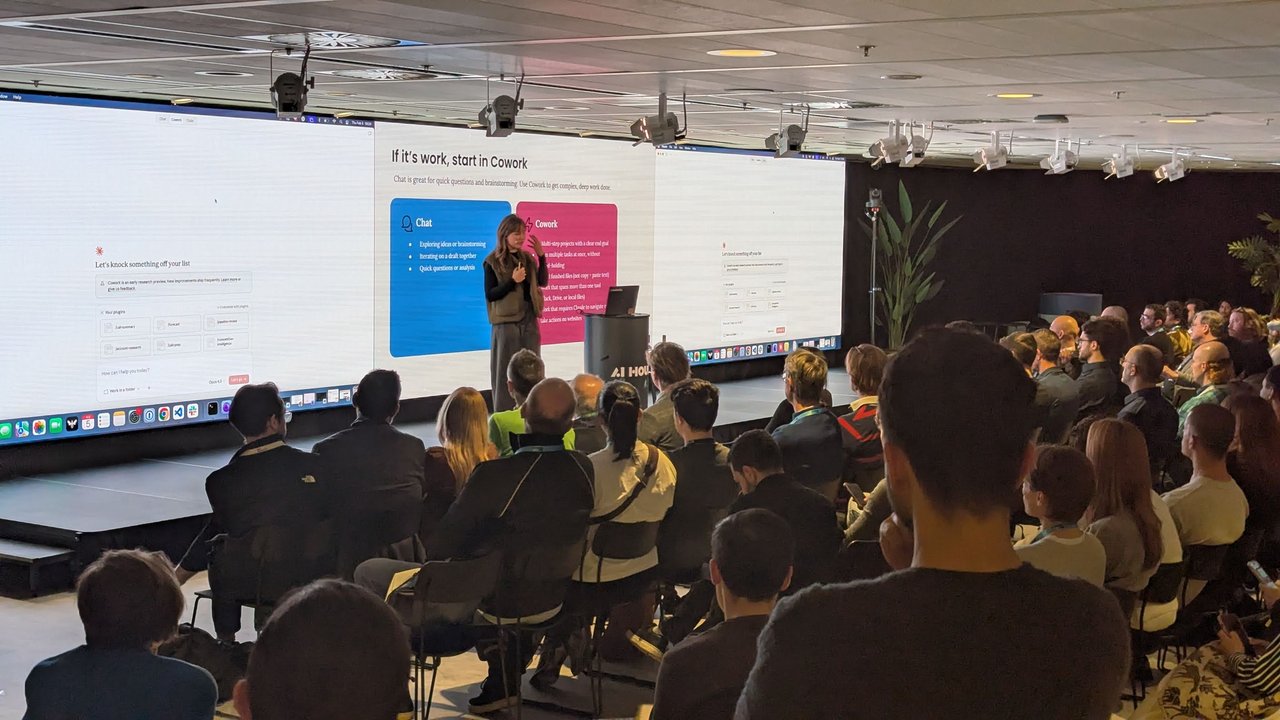 Speaker in front of the If it's work, start in Cowork slide comparing Chat and Cowork at AI House Amsterdam