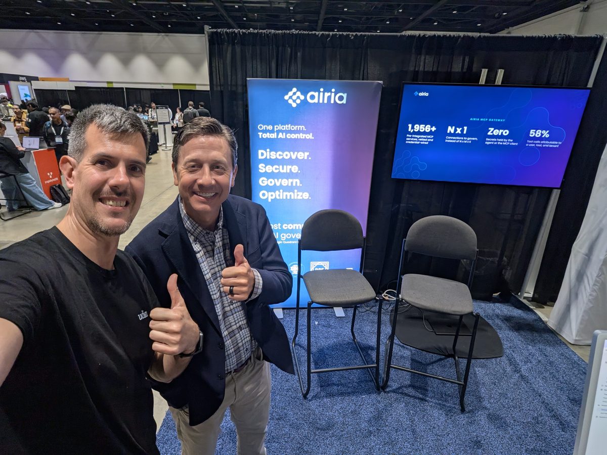 Luca Berton and Spencer Reagan giving a thumbs-up at the Airia booth