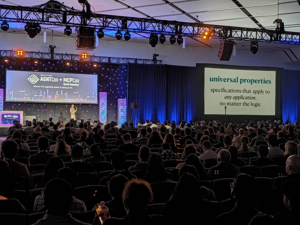 The full keynote hall in San Jose, the universal properties slide on the side screen