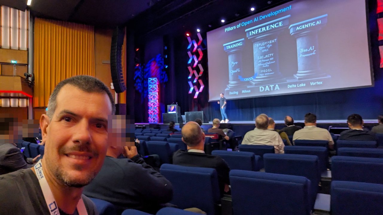Luca Berton in the AI_dev auditorium with the LF AI and Data Pillars of Open AI Development slide on stage