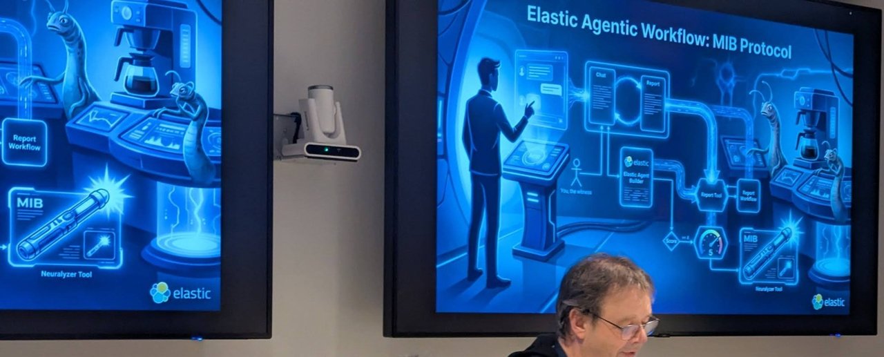 Hans Heerooms at his laptop under the Elastic Agentic Workflow: MIB Protocol slide, a playful diagram of a witness, a chat, Elastic Agent Builder, a report tool and a Neuralyzer tool