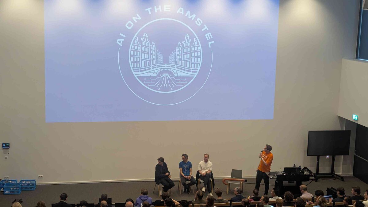 AI on the Amstel logo projected on stage with panelists