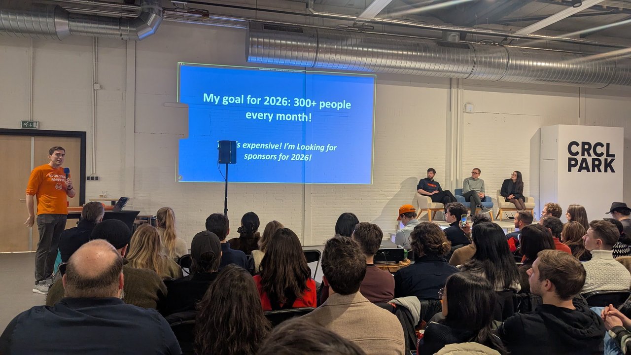 AI on the Amstel organiser on stage at CRCL Park in front of a slide reading My goal for 2026: 300+ people every month