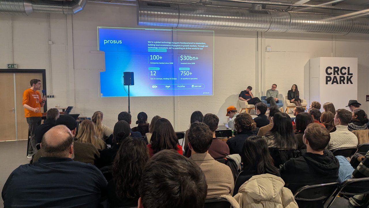 Prosus slide at the AI on the Amstel robotics meetup showing 100+ companies backed, $30bn+ invested since 2008 and 750+ AI workforce specialists