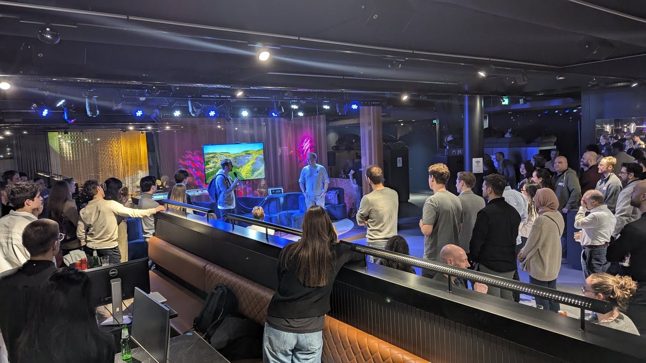 The crowd at AI Salon Amsterdam at The Flow, standing around the stage and railings