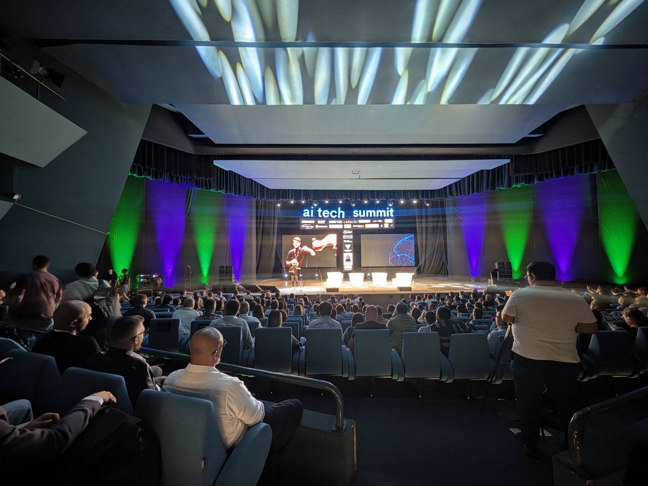 The main auditorium of the National Opera and Ballet in Skopje, seen from the back rows, with the illuminated ai tech summit sign above the stage