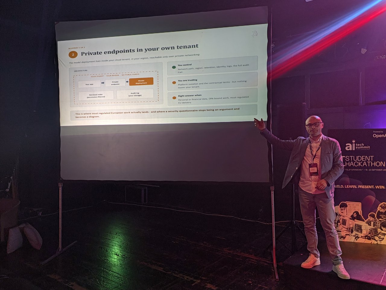 A speaker in front of a projected slide titled Private endpoints in your own tenant, with an architecture diagram marked your tenant, your region, no public egress