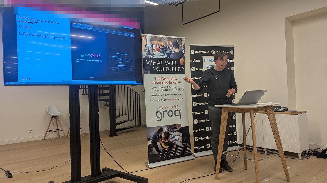 Max Engelen presenting a How to get access to GroqCloud slide pointing to console.groq.com, with the Groq LPU banner beside him