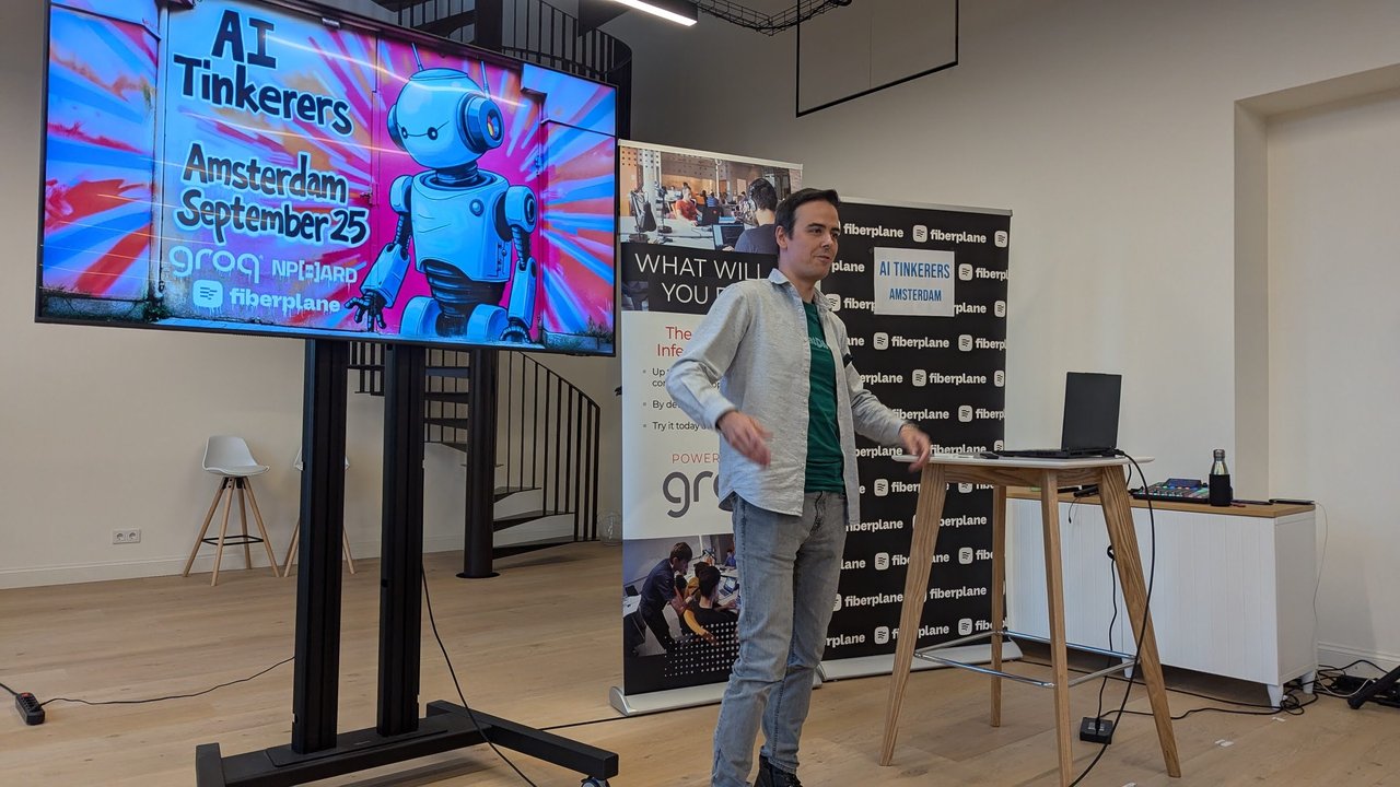 The AI Tinkerers Amsterdam September 25 title slide with a cartoon robot and the Groq, NP-HARD and Fiberplane logos, with the host beside the screen