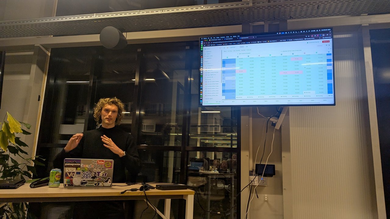The orq.ai experiment view with rows of PASSED and a few FAILED results from a JSON schema evaluator and a tone of voice evaluator