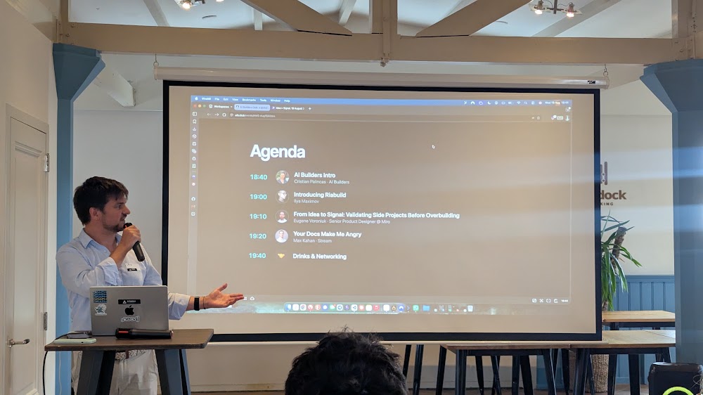 AI Builders Amsterdam agenda slide projected on screen