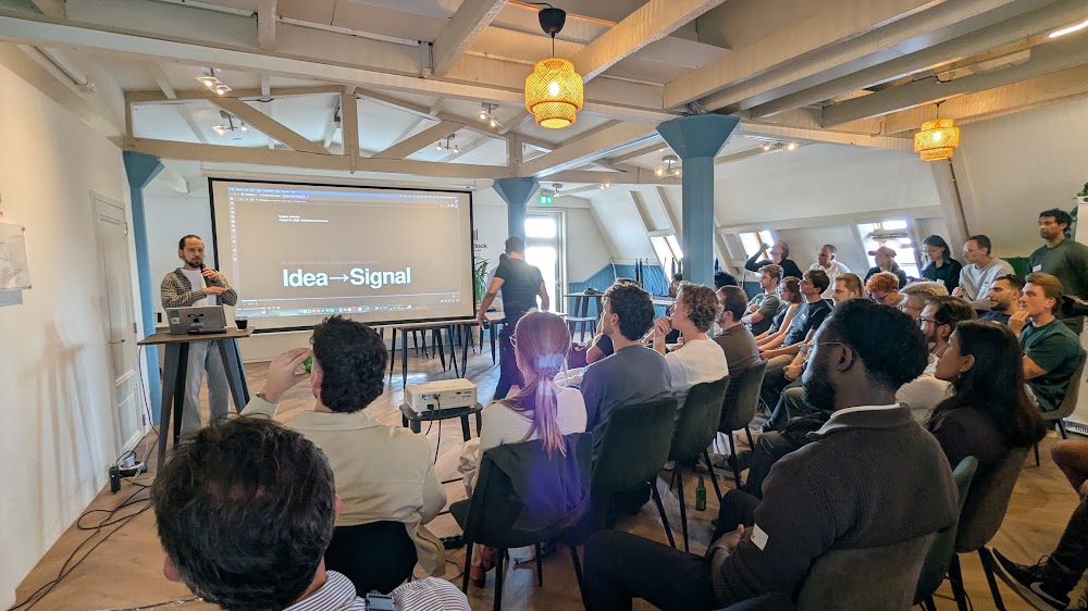 Audience of around 40 people seated and listening to the Idea to Signal talk