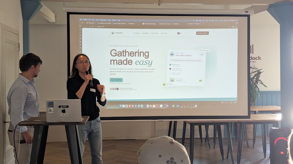 Presenter demoing the GatherEZ AI agent on stage at the meetup
