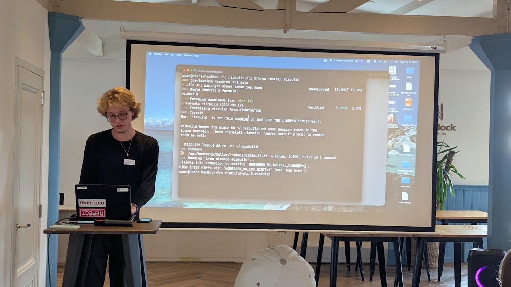 Live Riabuild demo: terminal commands projected on screen at the meetup