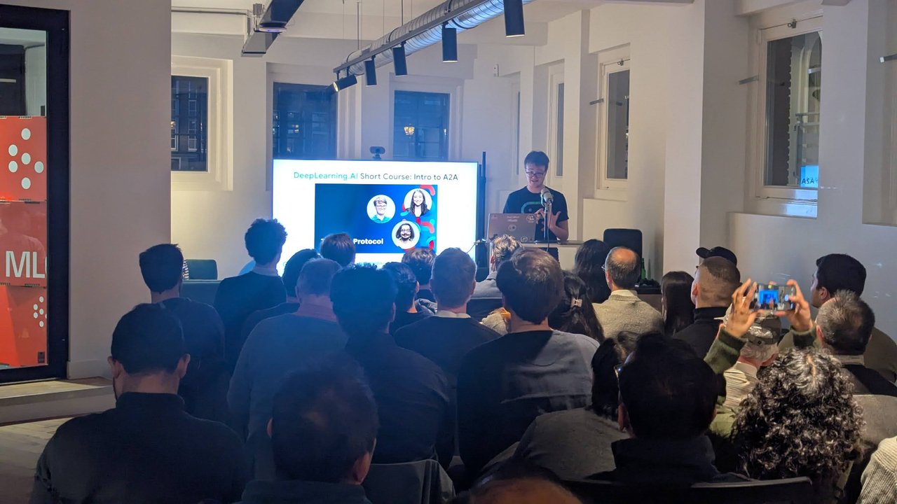 Google Cloud speaker presenting the DeepLearning.AI Short Course Intro to A2A Protocol slide to a full room at ML6 Amsterdam