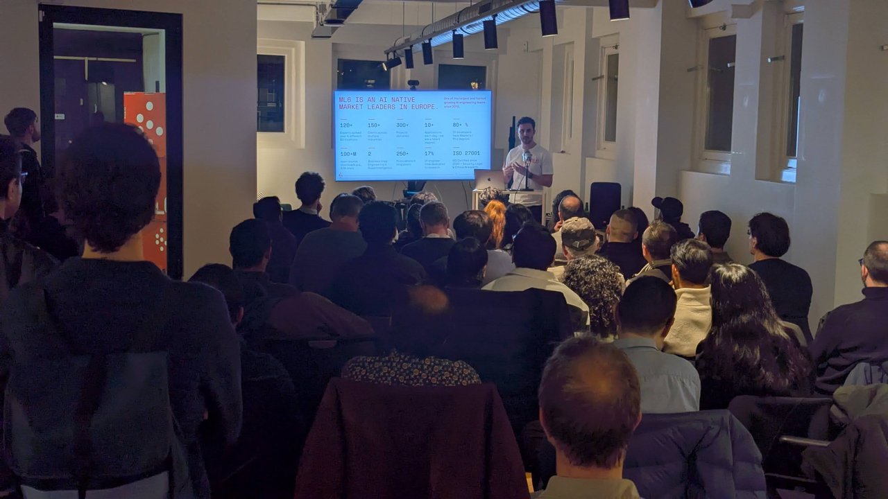 ML6 speaker presenting the ML6 company introduction slide with key figures to the AICamp audience