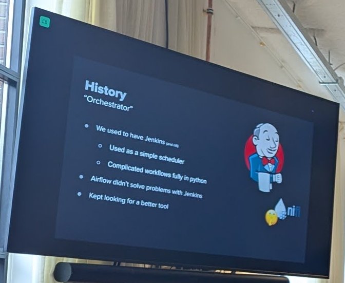 A History Orchestrator slide listing Jenkins as a simple scheduler and Airflow not solving the problems