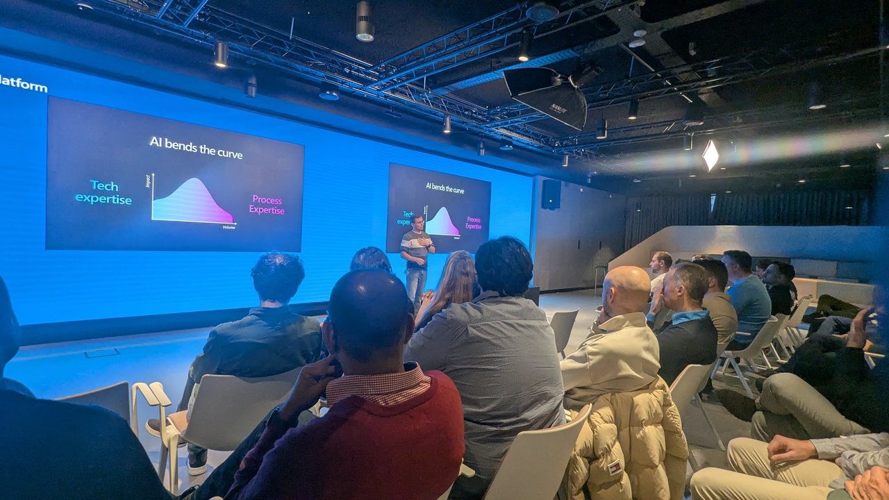 The slide AI bends the curve, plotting tech expertise against process expertise, on the screens during Albert-Jan Schot's Power Platform vibe coding talk
