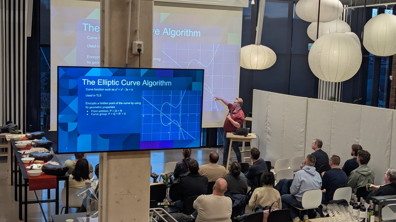 Speaker pointing at the plotted curve on The Elliptic Curve Algorithm slide, showing point addition P + Q = R, at the Amsterdam Java User Group