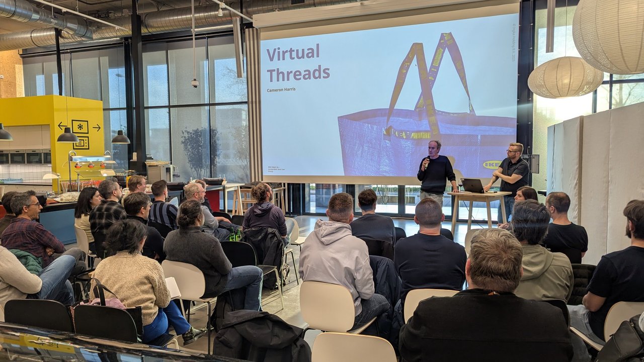 Title slide of the Virtual Threads talk by Cameron Harris at the IKEA Meet Up of the Amsterdam Java User Group, with an IKEA bag on the slide