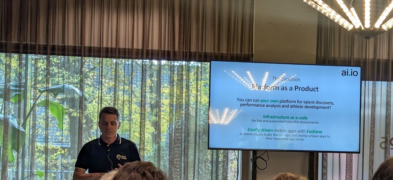 ai.io speaker presenting the slide The Evolution, Platform as a Product: run your own platform for talent discovery, performance analysis and athlete development, infrastructure as code and config-driven mobile apps with Fastlane