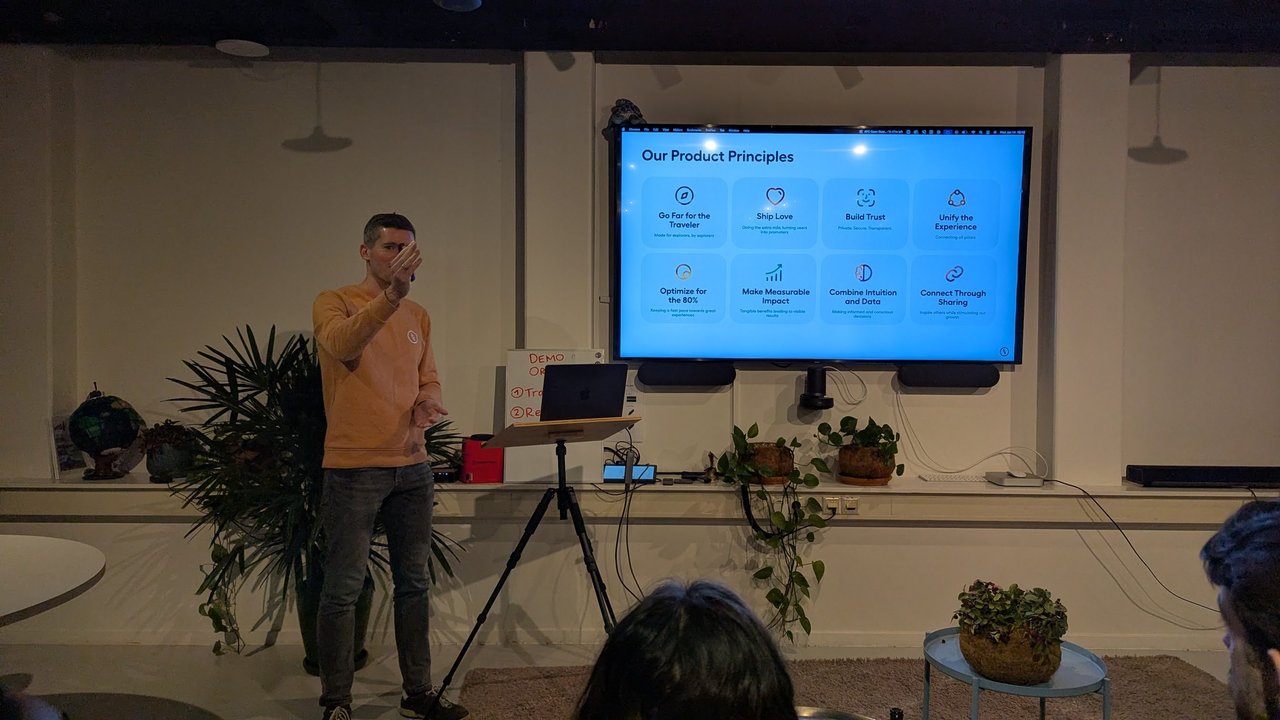 A Polarsteps speaker presenting the Our Product Principles slide with eight principles