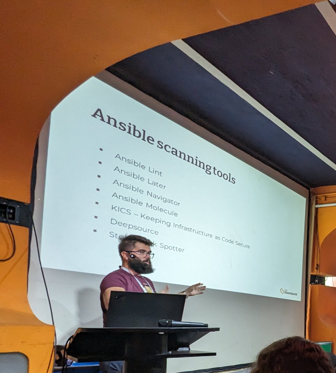 The "Ansible scanning tools" slide from the Steampunk session at c-base, listing Ansible Lint, Ansible Later, Ansible Navigator, Ansible Molecule, KICS, Deepsource and Steampunk Spotter