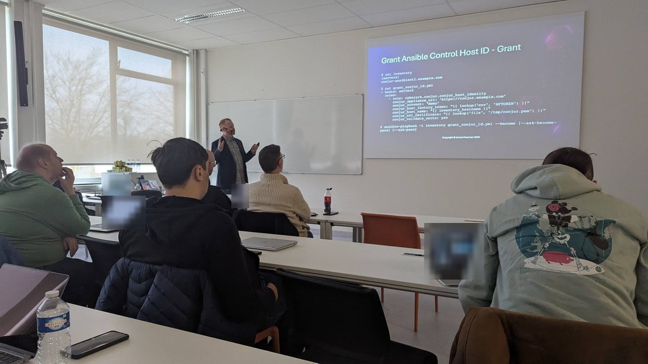A CfgMgmtCamp 2025 slide titled Grant Ansible Control Host ID - Grant, showing an inventory and a playbook that applies the cyberark.conjur.conjur_host_identity role with appliance URL, account, host factory token and SSL certificate variables