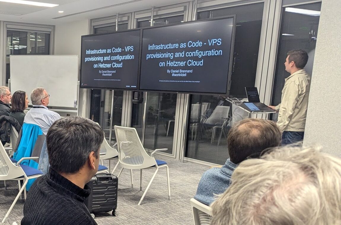 Daniel Brennand presenting the title slide 'Infrastructure as Code - VPS provisioning and configuration on Hetzner Cloud' at the Ansible London meetup