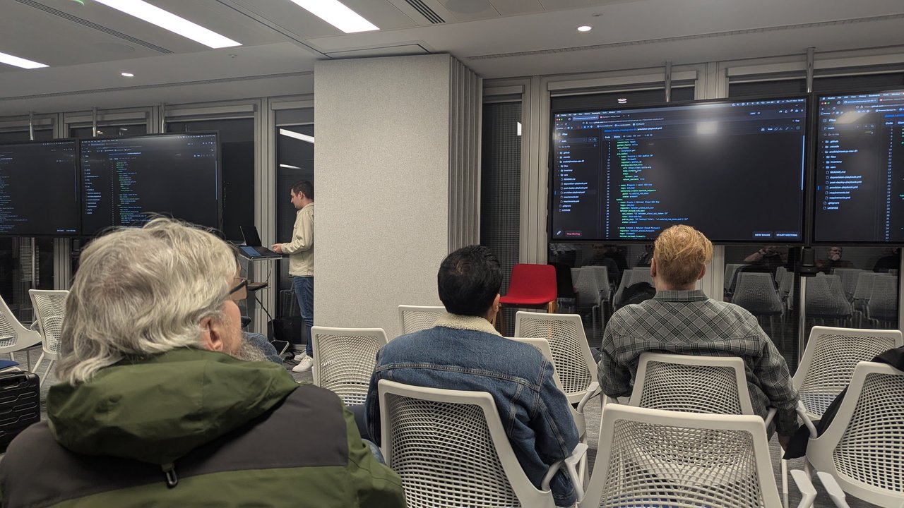 The provision-playbook.yml file from the dbrennand/demos repository on the meetup screens, showing hetzner.hcloud tasks