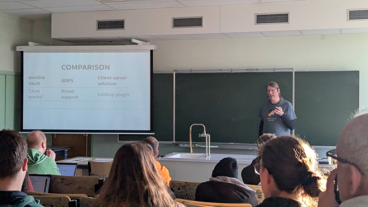 A "Comparison" slide at CfgMgmtCamp 2025 in Ghent with three columns: Ansible Vault "just works", SOPS has broad support, and a client-server solution uses a lookup plugin