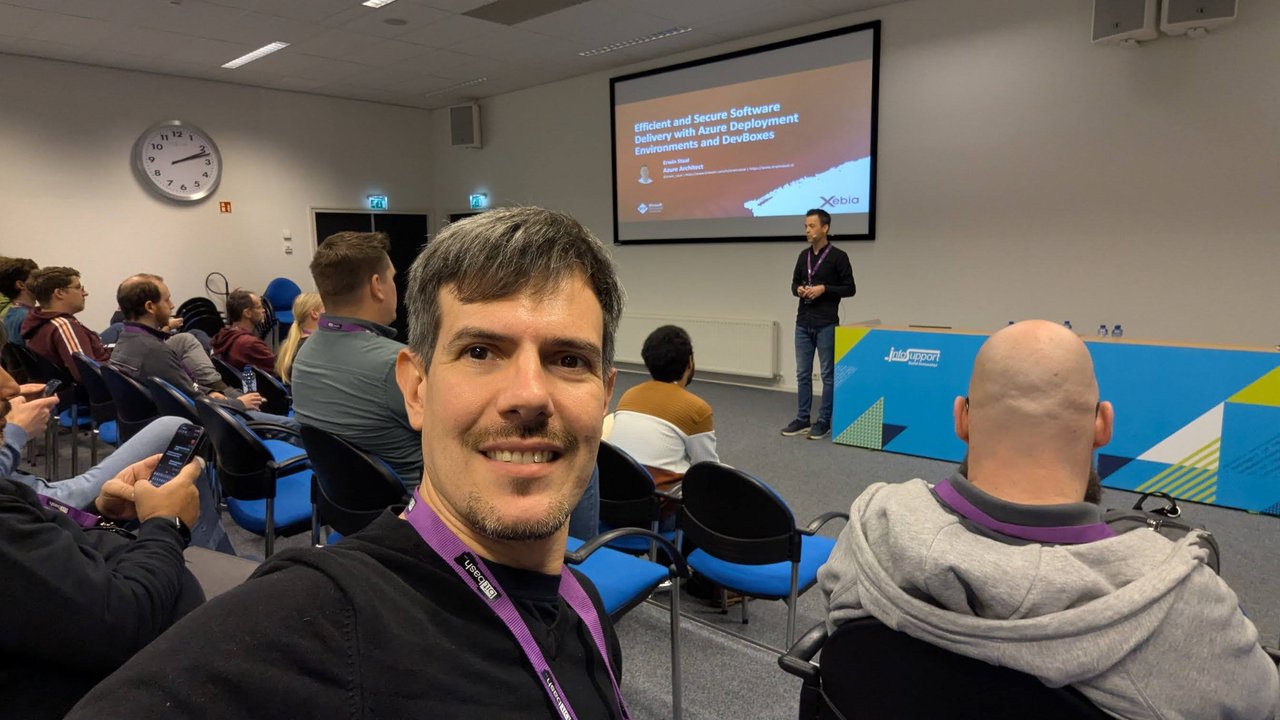 Luca Berton in the audience at BitBash 2025, with Erwin Staal presenting the Efficient and Secure Software Delivery with Azure Deployment Environments and DevBoxes title slide