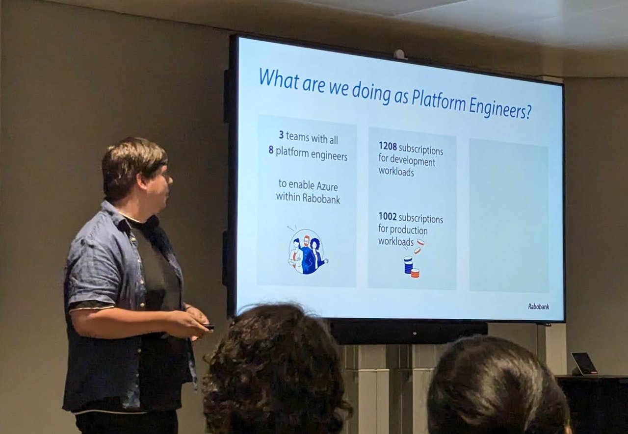 A Rabobank platform engineer presenting a slide titled What are we doing as Platform Engineers, with 3 teams, 8 platform engineers and the subscription counts