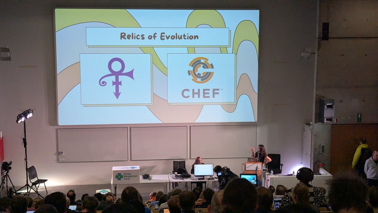 A full lecture hall at CfgMgmtCamp 2025 in Ghent during the Relics of Evolution talk about Chef