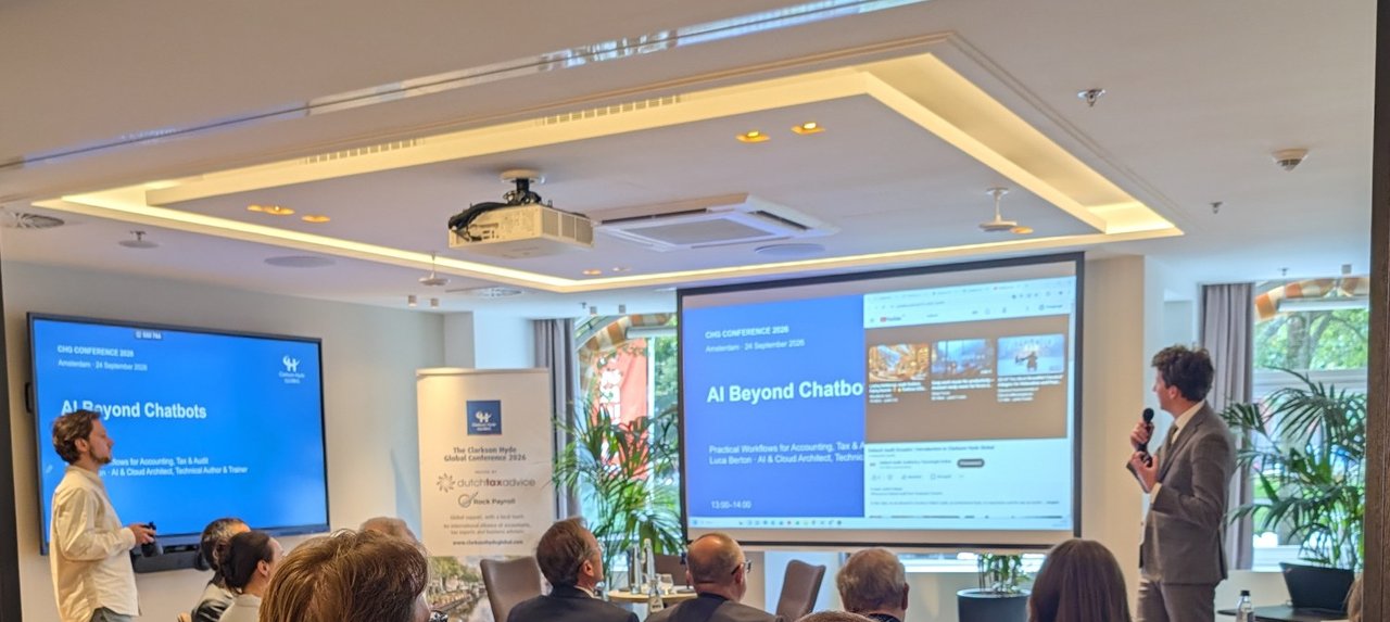 Meeting room at the Clarkson Hyde Global Conference 2026 with the AI Beyond Chatbots slide on two screens and attendees seen from behind