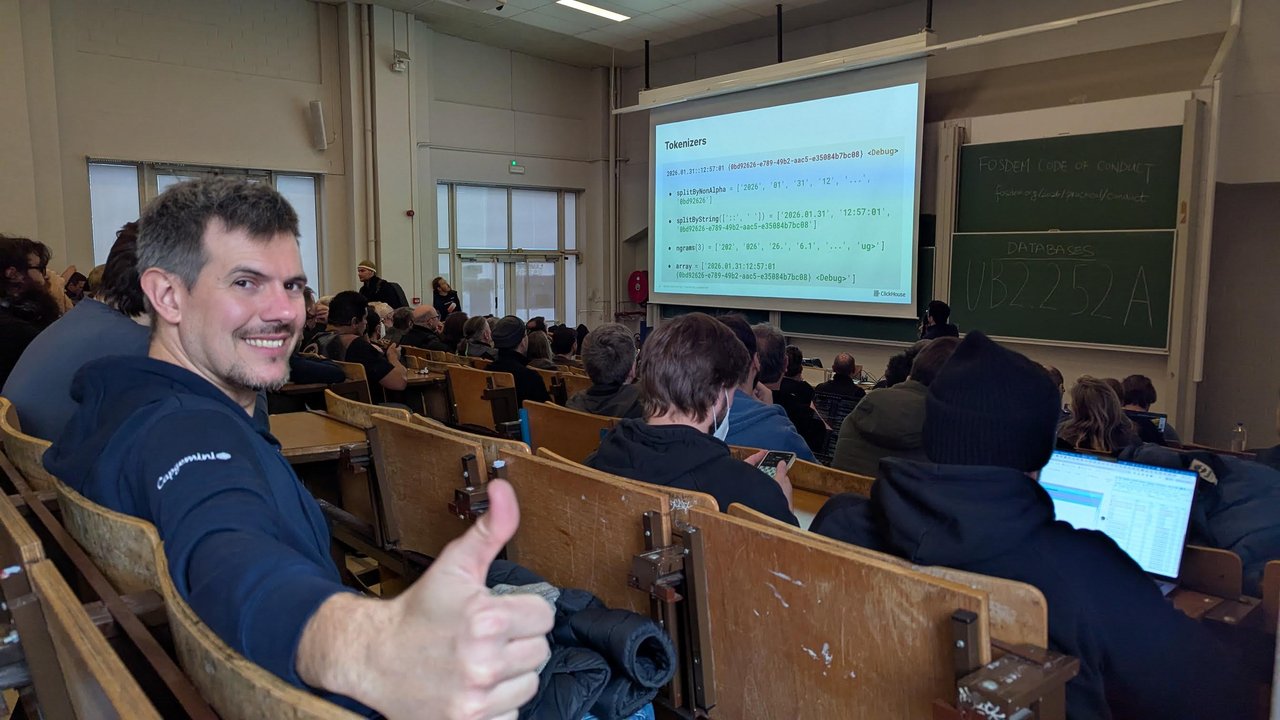 The Tokenizers slide in room UB2.252A at FOSDEM 2026, showing one log line split by splitByNonAlpha, splitByString, ngrams(3) and array