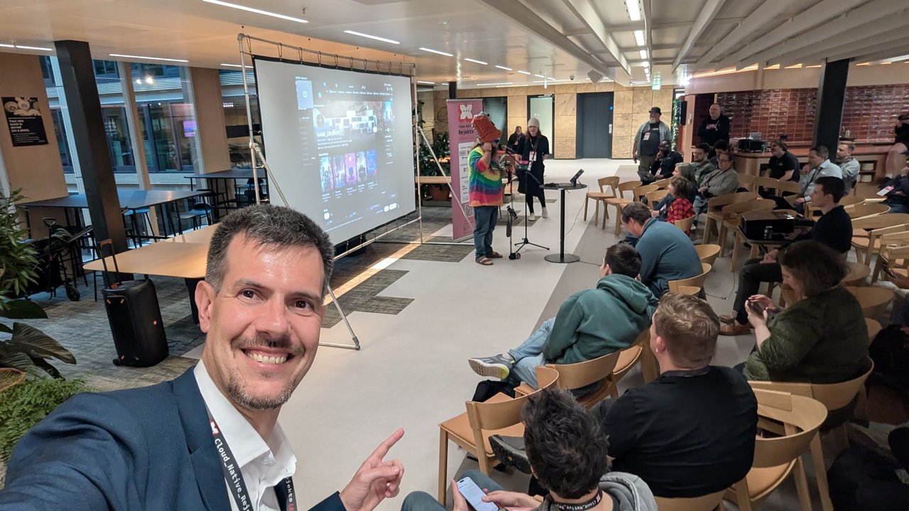 Luca Berton pointing at the stage during the late afternoon sessions at Cloud Native Rejekts 2026 in Amsterdam
