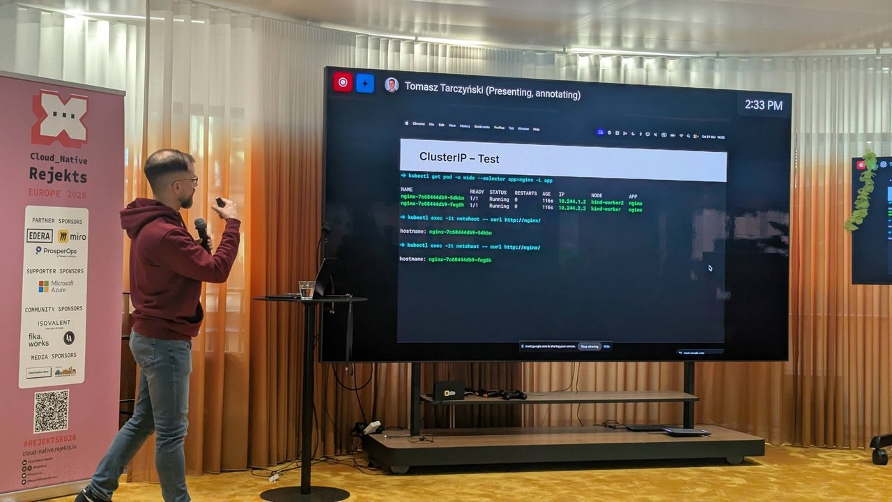 Tomasz Tarczyński presenting a ClusterIP Test slide with kubectl output from a kind cluster at Cloud Native Rejekts 2026