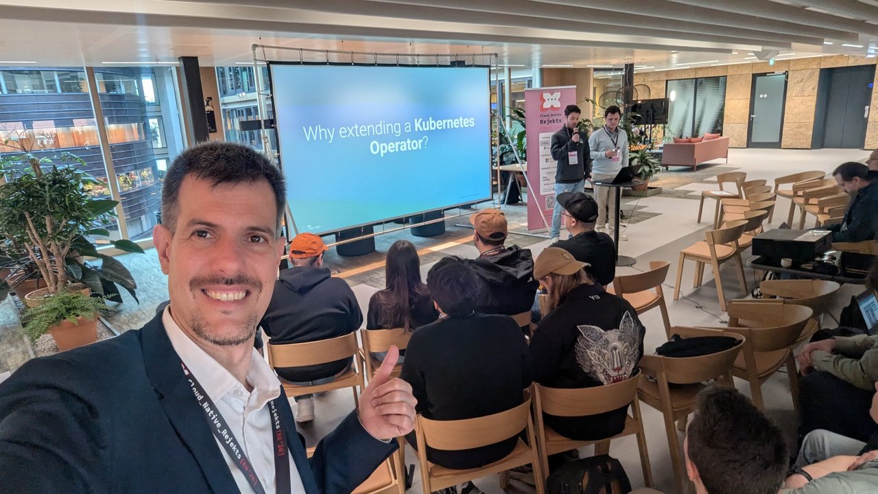 Luca Berton in the audience of the Solving Operator Extensibility talk on a gRPC plugin framework for Kubernetes at Cloud Native Rejekts 2026