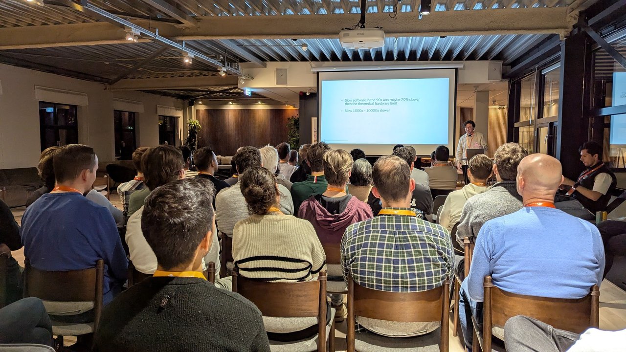 Slide at the Cloudflare meetup in Amsterdam comparing slow software in the 90s at 70 percent below hardware limits with today's 1000x to 10000x