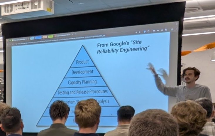 A slide titled From Google's Site Reliability Engineering showing a pyramid with product, development, capacity planning and testing and release procedures
