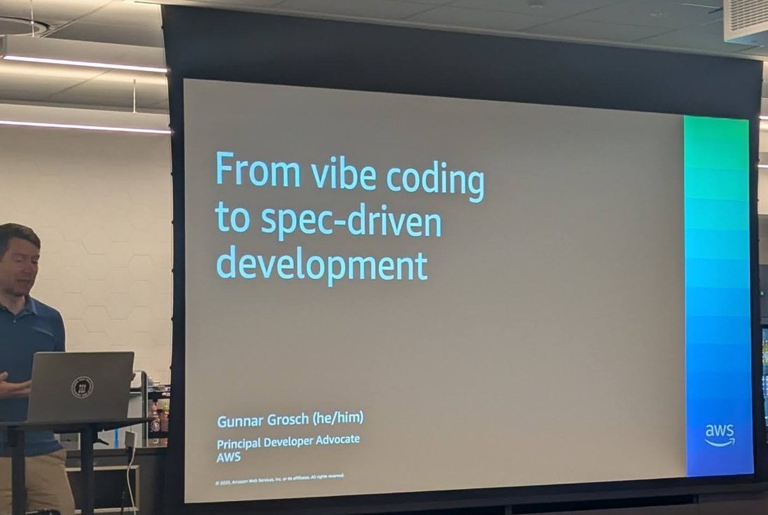 Gunnar Grosch next to his title slide, From vibe coding to spec-driven development, with the AWS logo
