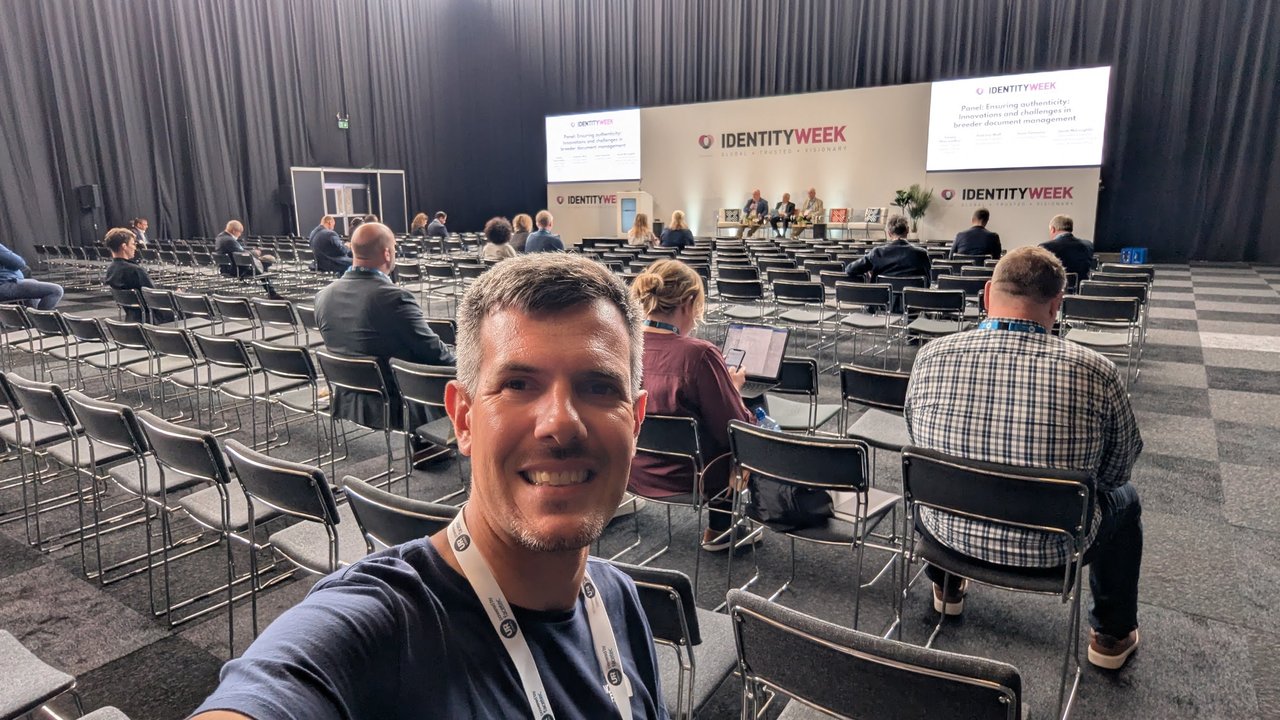 Identity Week Europe stage with a panel on ensuring authenticity in breeder document management and mostly empty rows of chairs