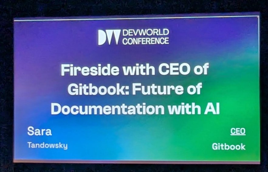 Stage with a DevWorld Conference slide: Fireside with CEO of Gitbook, Future of Documentation with AI, Sara Tandowsky, CEO Gitbook